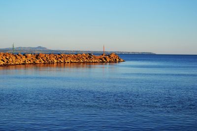 Scenic view of sea against clear blue sky