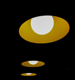 Illuminated yellow light against black background