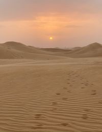 Scenic view of desert against sky during sunset