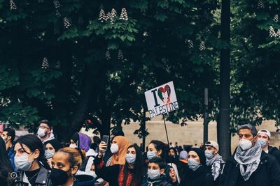 Group of people standing against plants