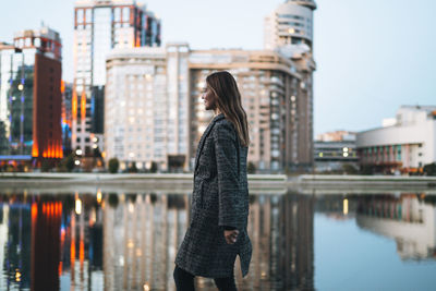 Rear view of woman standing in city