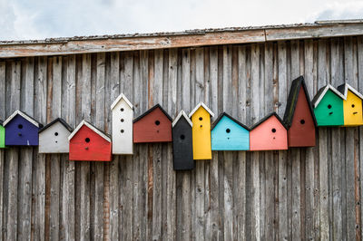 Colorfull bird boxes on wall