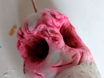 Close-up of pink rose against white background