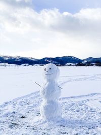 Snow on field against sky during winter