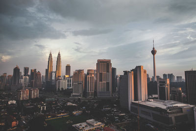 City skyline against cloudy sky