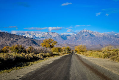 Morning road to the mountains with autumn trees