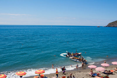 High angle view of people on sea against sky