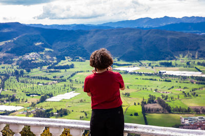 Young woman at a viewpoint over the  sopo valley at the department of cundinamarca in colombia