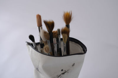 High angle view of paintbrushes on white background