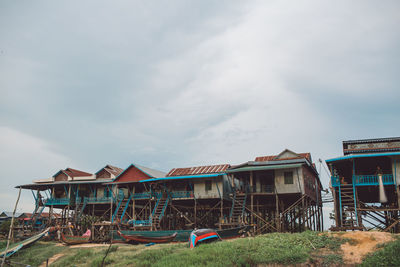 Houses on field against sky