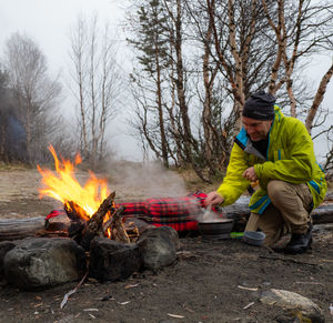 Full length of man holding fire in park