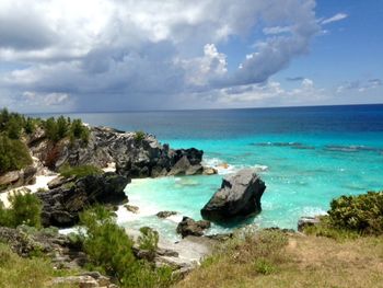 Scenic view of sea against cloudy sky