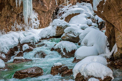 Snow covered rocks on land