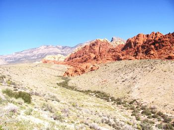 Scenic view of mountains against clear blue sky