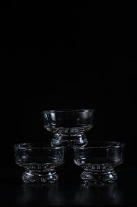 Glass bowls against black background