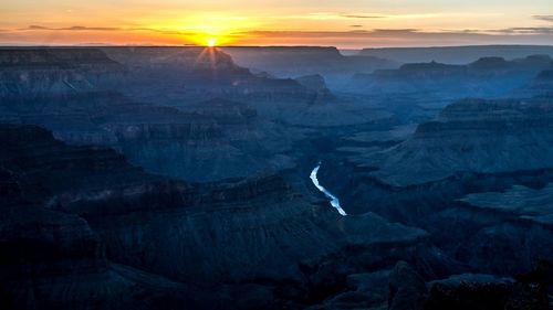 Colorado river in grand canyon national park against sky during sunset