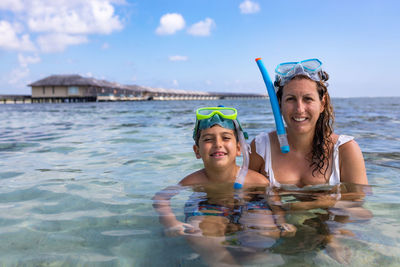 Mother and son snorkeling on the maldive islands