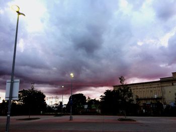 View of city street against cloudy sky