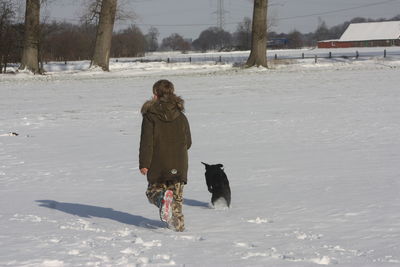 Full length of a dog on snow covered land