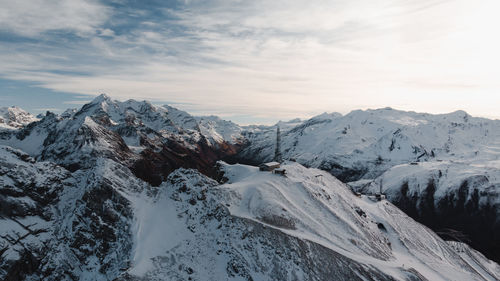 Scenic view of snow covered mountains against sky