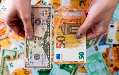 Cropped hand holding paper currency