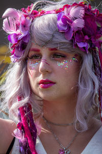 Close-up portrait of woman with pink flowers