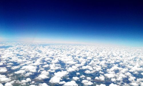 Aerial view of landscape against cloudy sky