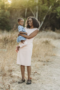 Full length portrait of smiling woman