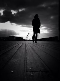 Rear view of woman standing on road