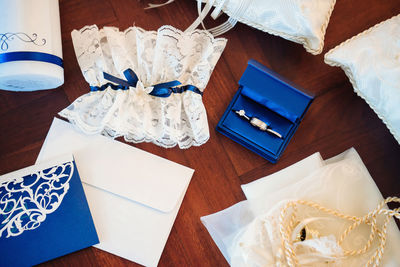 Directly above shot of envelopes and lace on wooden table