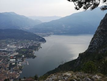 Aerial view of townscape by mountains against sky