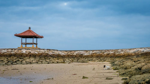 Lifeguard hut on beach against sky