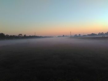 Scenic view of field against sky during sunset