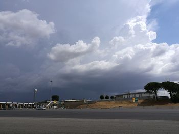 Road by beach against sky