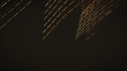 Low angle view of illuminated building against sky at night