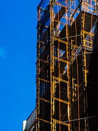 Low angle view of built structure against clear blue sky