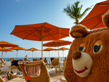 View of stuffed toy on beach against clear sky