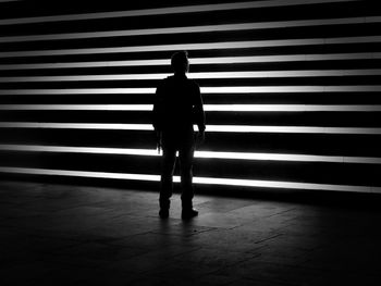 Silhouette man standing on floor at night