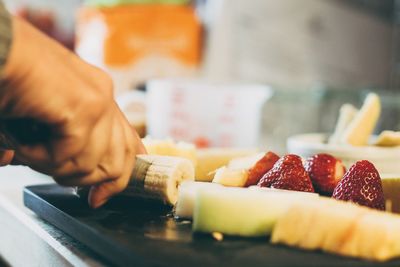 High angle view of person cutting fruits