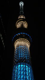 Low angle view of illuminated building lit up at night