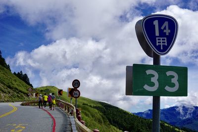 Road sign against sky