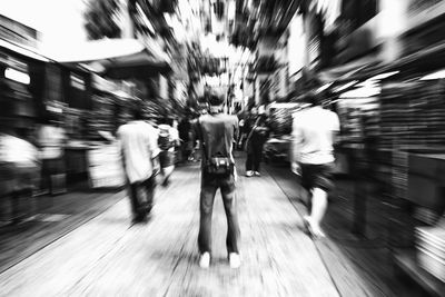 Blurred motion of people walking on city street