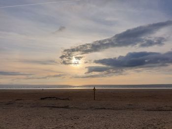 Scenic view of beach against sky during sunset