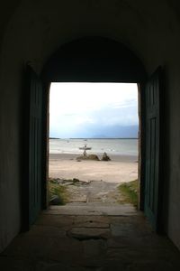 Scenic view of sea against sky seen through window