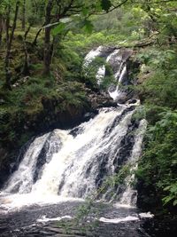 Scenic view of river flowing through rocks