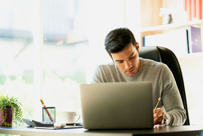 Man using laptop on table