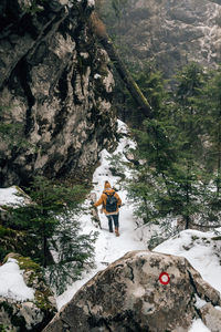 Man standing on rock against mountains