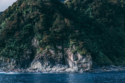 Scenic view of sea by rock formation