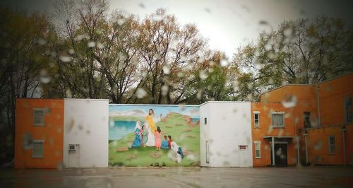 People on street by building against sky