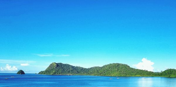 Scenic view of sea against clear blue sky